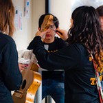 photo of students adjusting their instrument for the Sound of Music event at the 2012 MSO Tournament